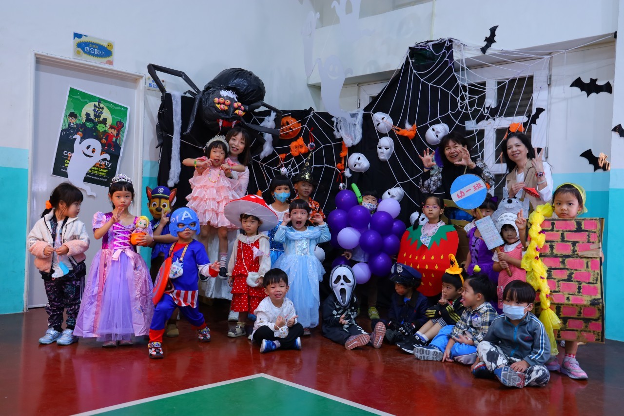 Children in Halloween costumes in a decorated classroom